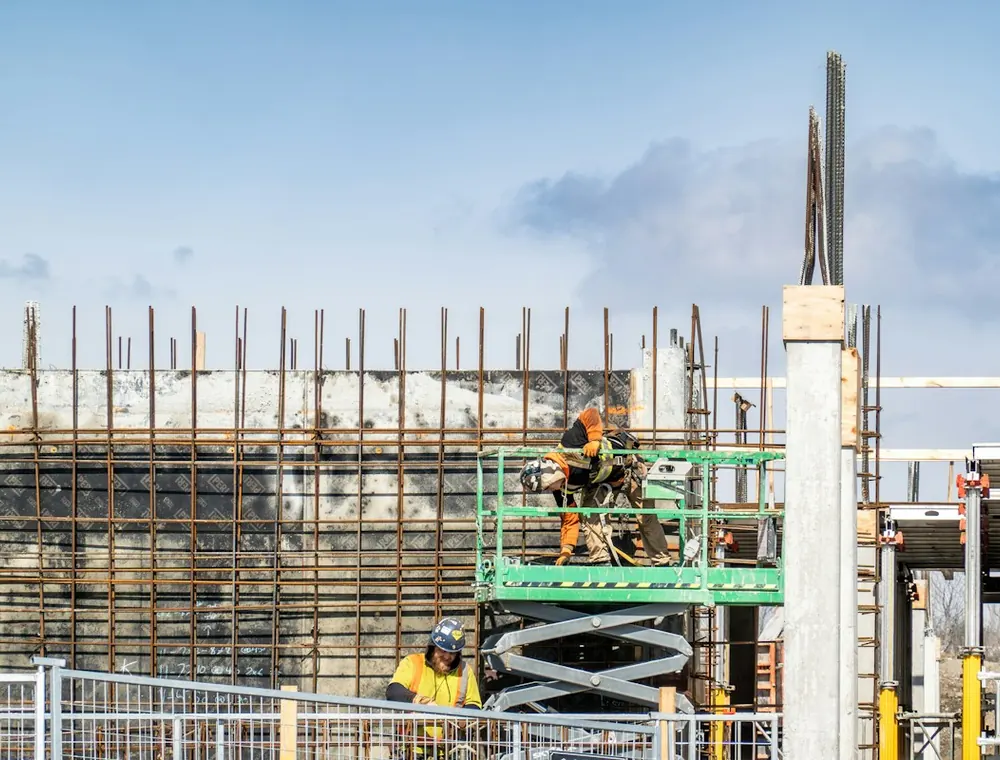 Construction crew working on a commercial building frame