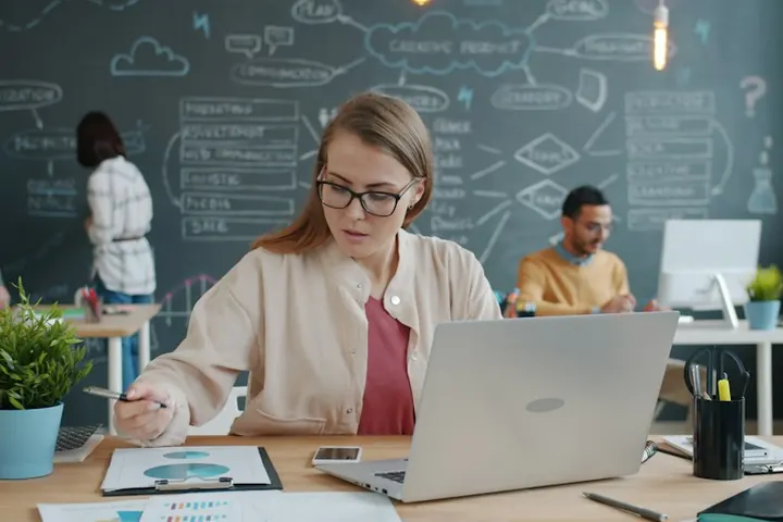 Business owner reviewing payroll on a laptop