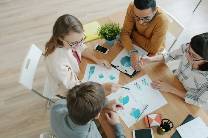 Team reviewing printed financial charts