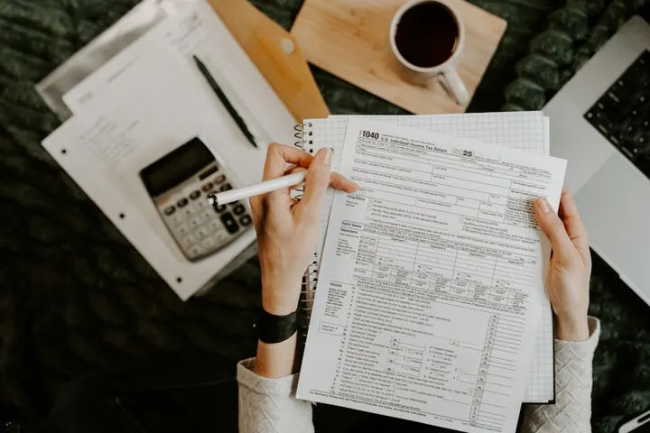 Tax forms and a calculator on a desk